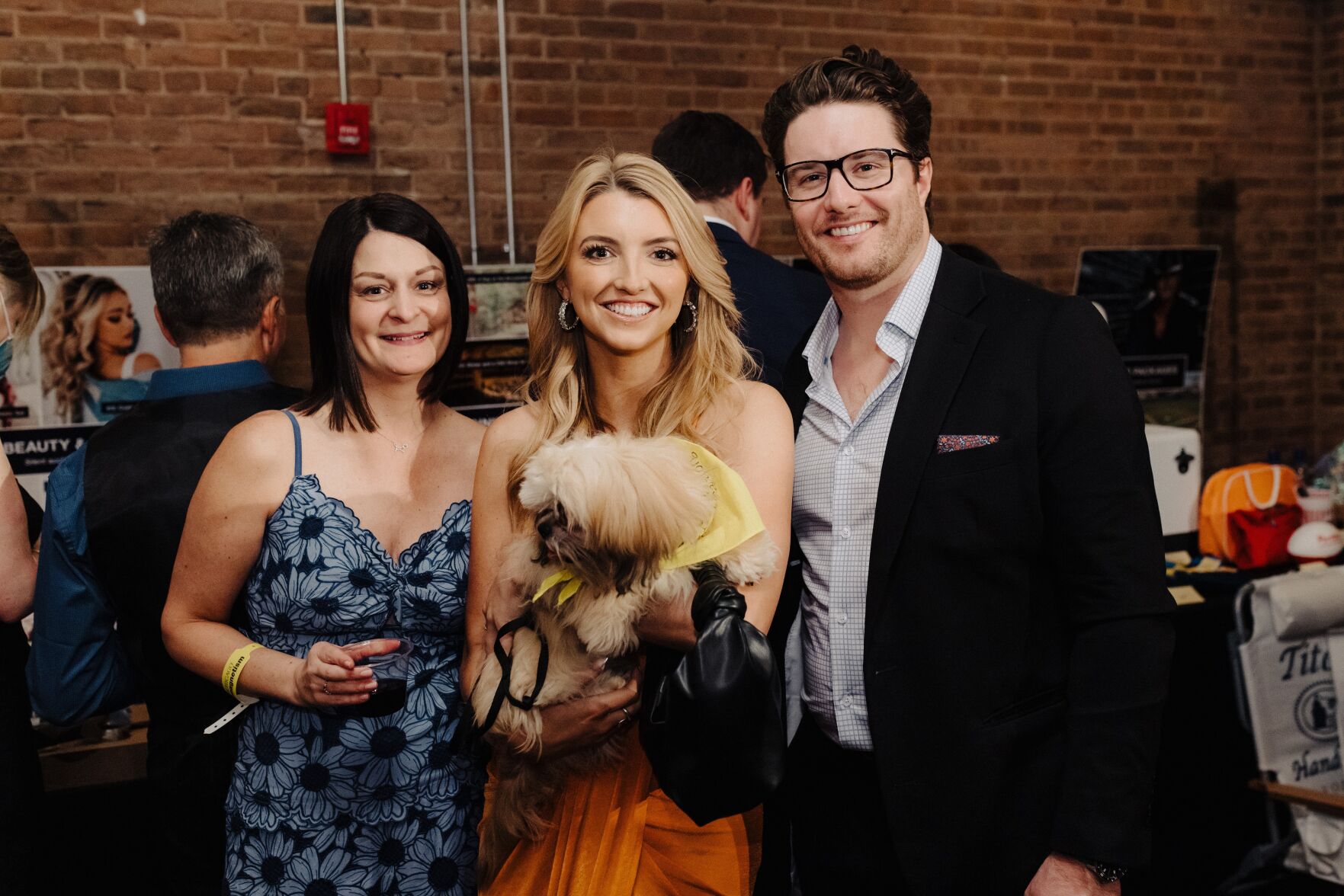 Co-Chairs Sarah Atkinson and Paige Krueger with Liam O'Connor and adoptable PAWS pet Jimmy. (Photo PAWS Chicago)